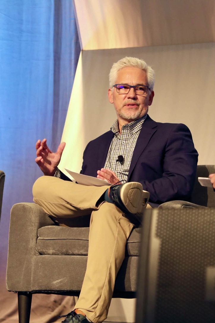 Leo Anderson speaking on a conference stage